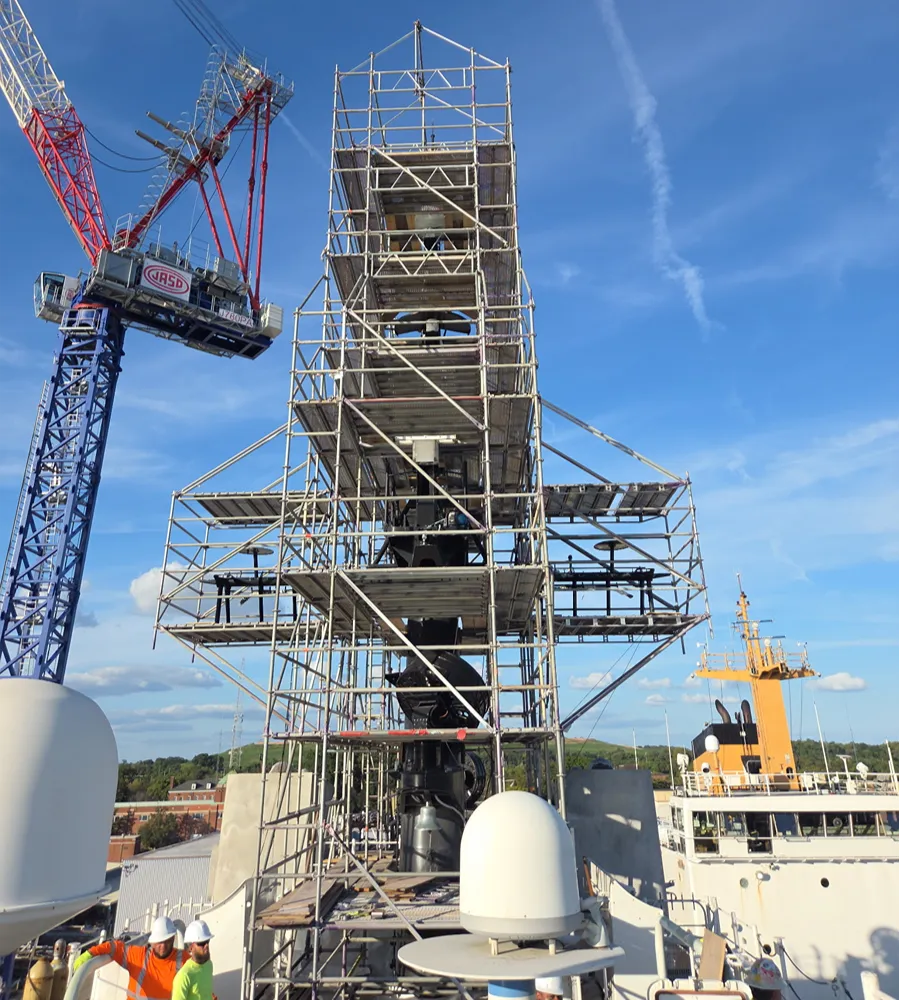 Vessel in dry dock surrounded by marine scaffolding and containment